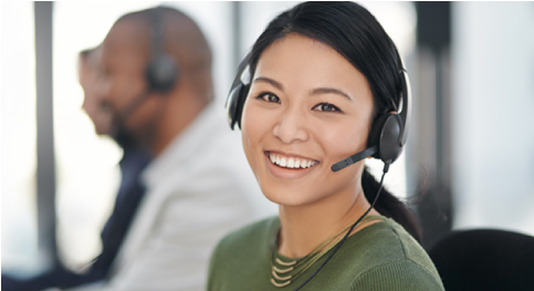 A woman with a headset smiling to the camera