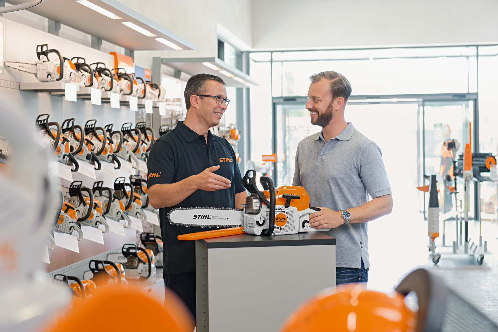 A STIHL dealer helps a customer buying a STIHL chainsaw