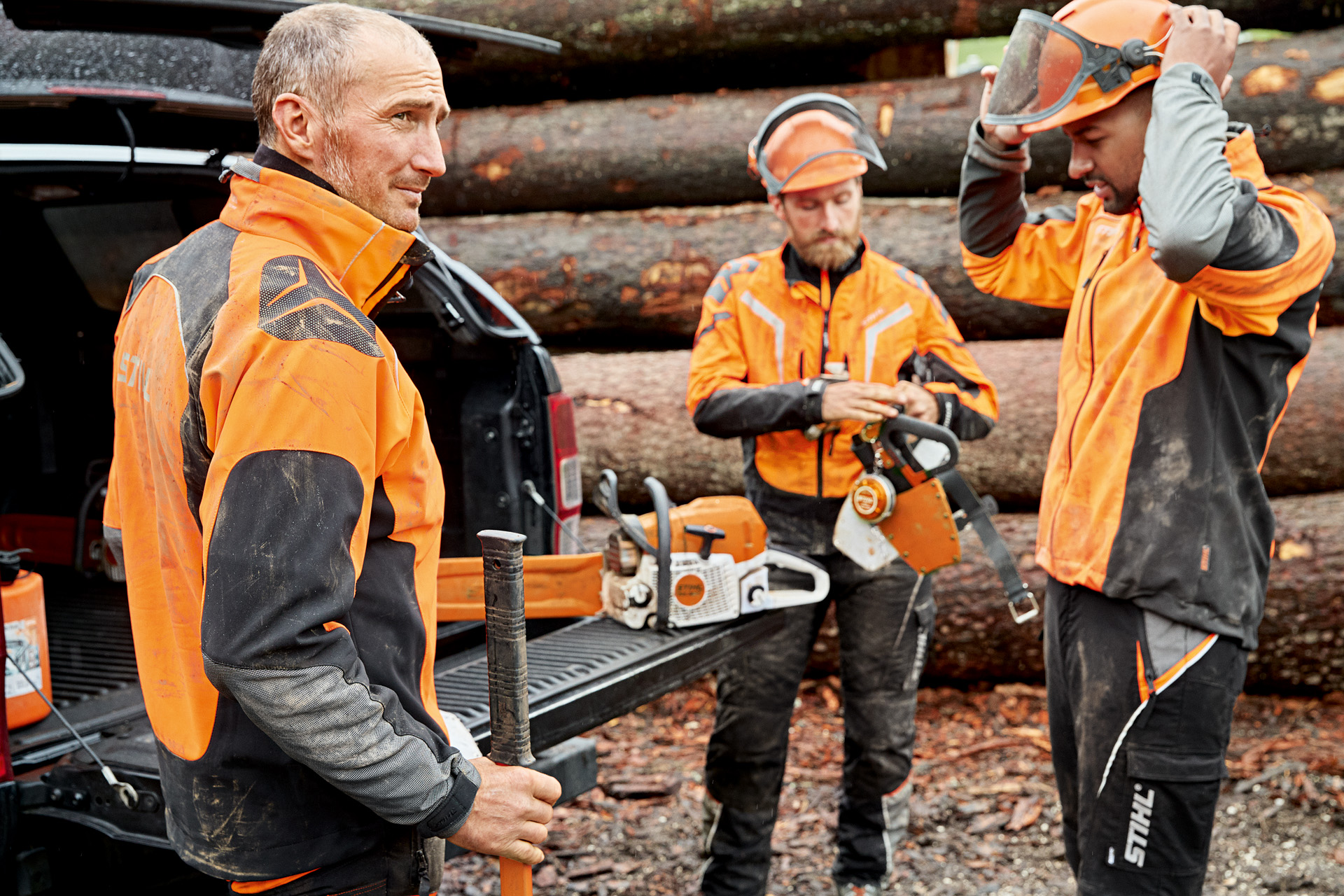 A group of professionals are getting ready for work in their protective clothes 